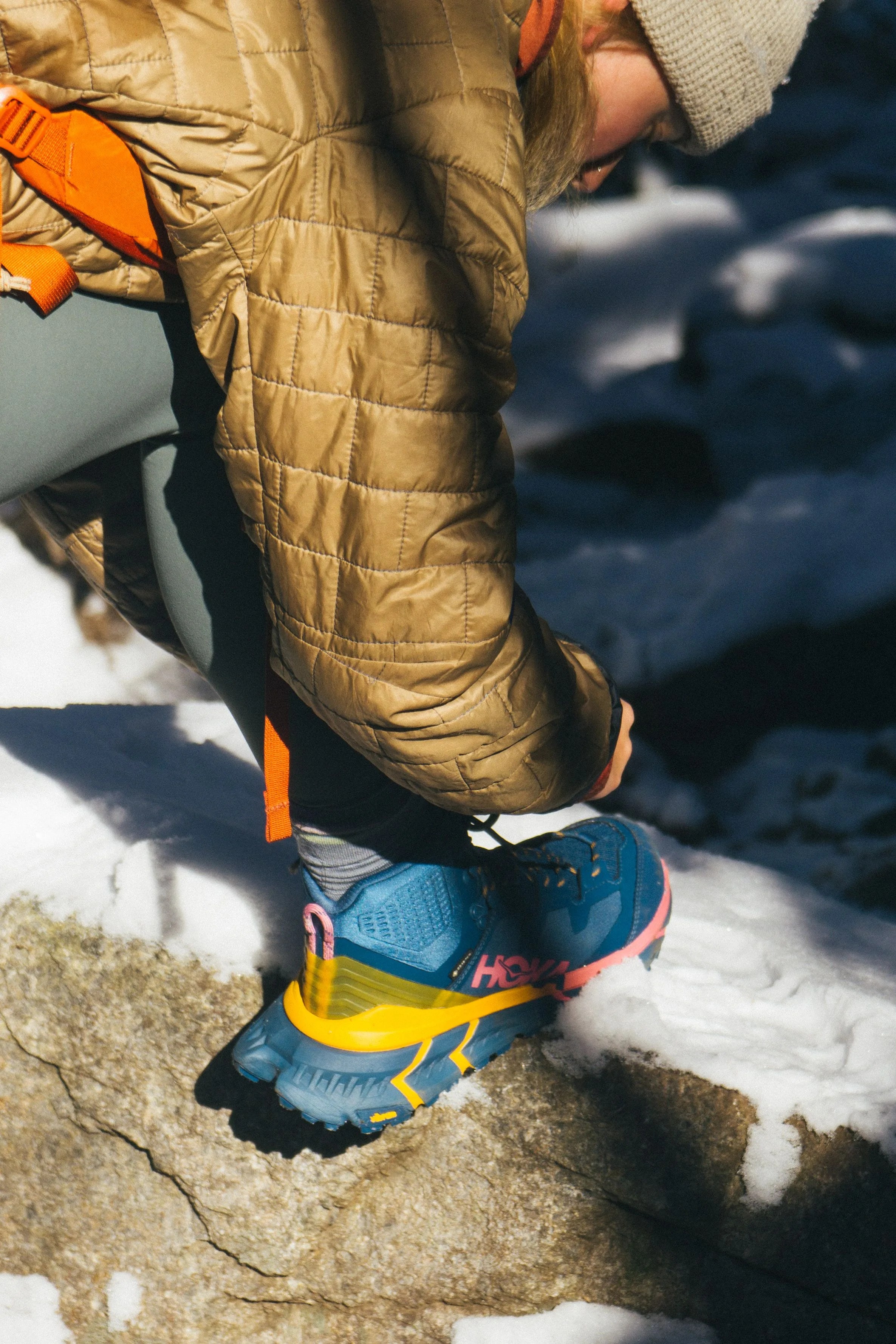 someone tying a hiking boot