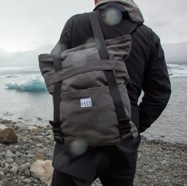 a model with a backpack near icebergs