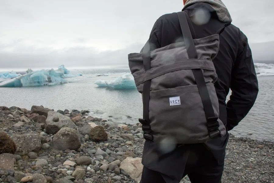 a model with a backpack near icebergs
