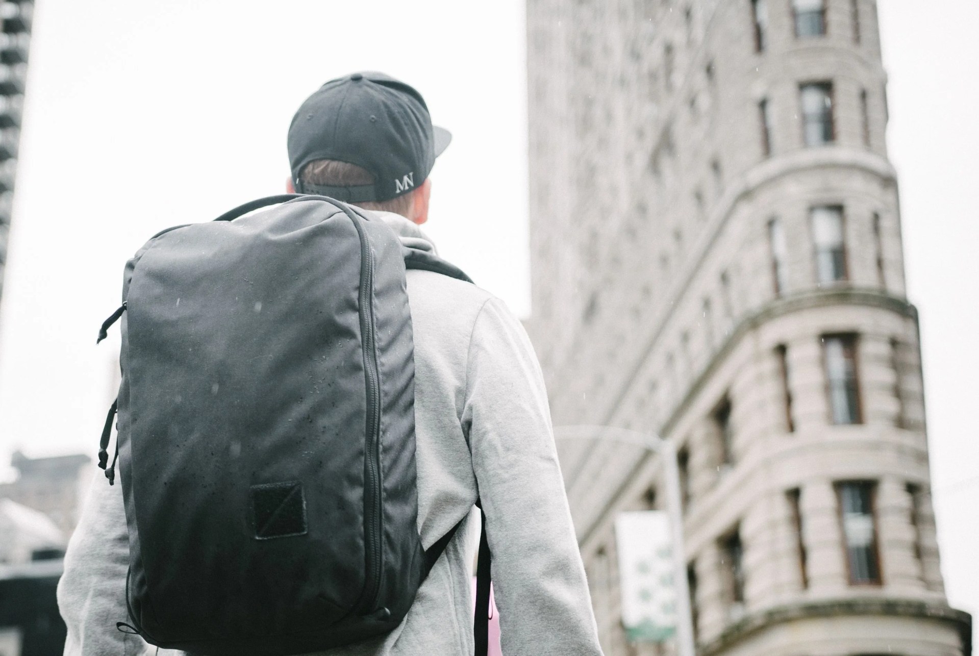 man wearing backpack at flatiron building