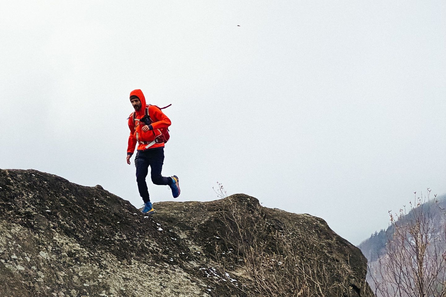 a man running on a rock ledge