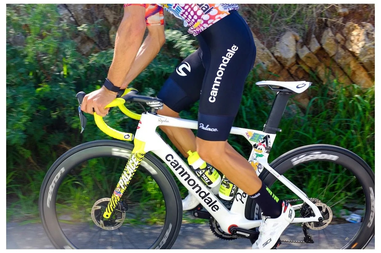 a man riding a white road bike