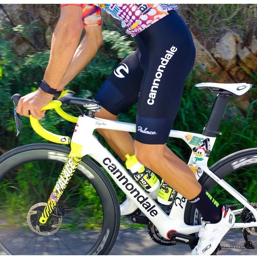 a man riding a white road bike