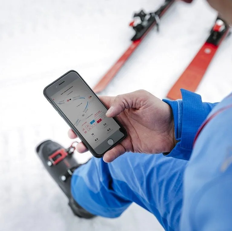 a skier looking at his phone