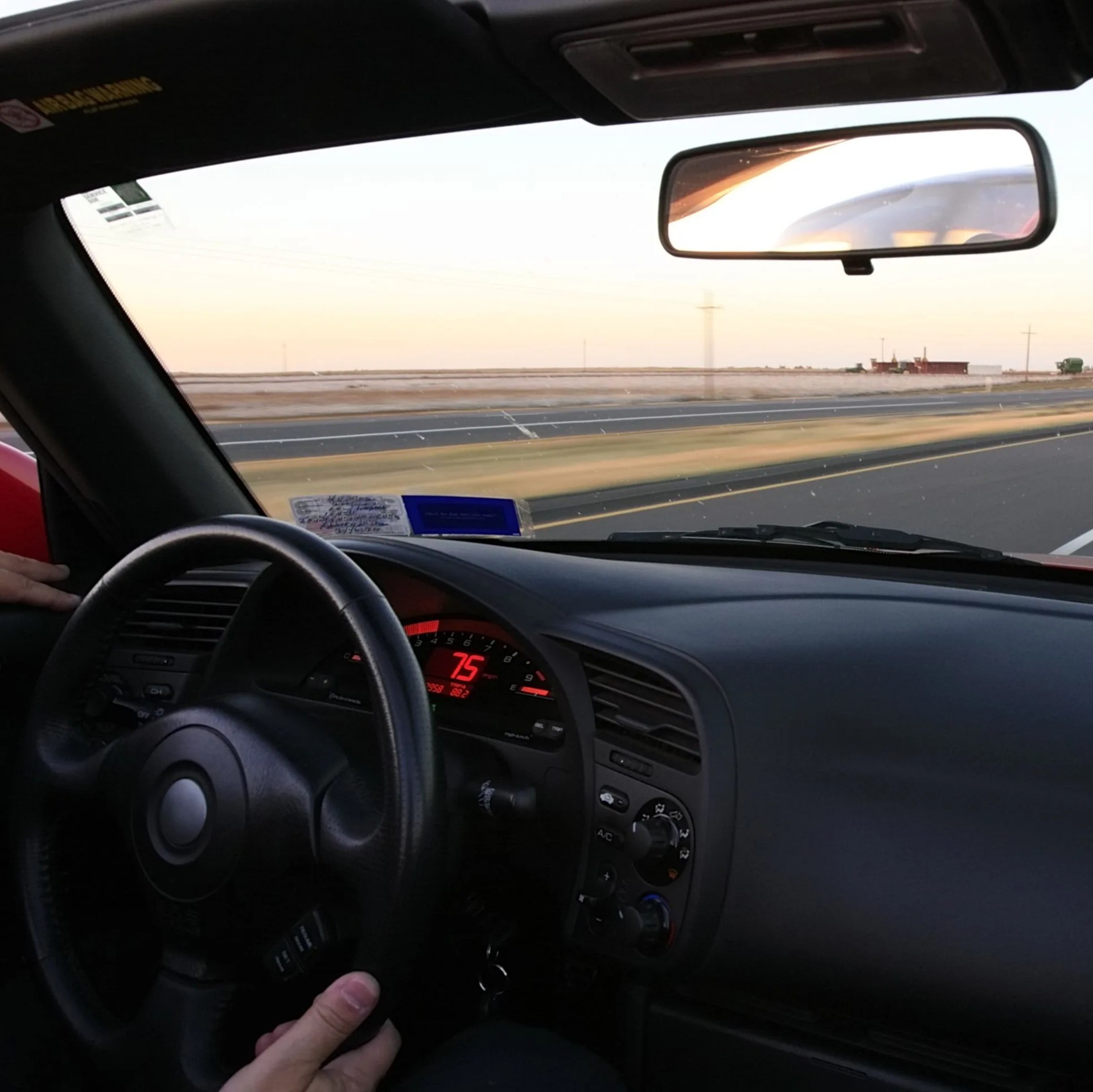 cruising at 75 mph in a red convertible sports car