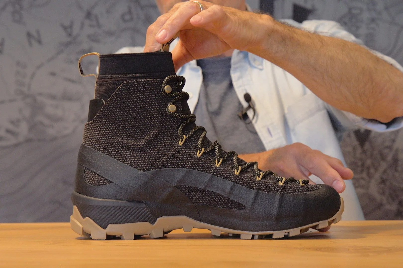 a black full sized hiking boot made of kevlar on a table
