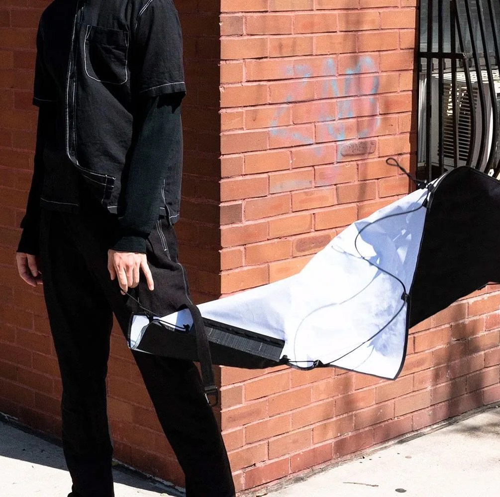 a man holding a flat bag