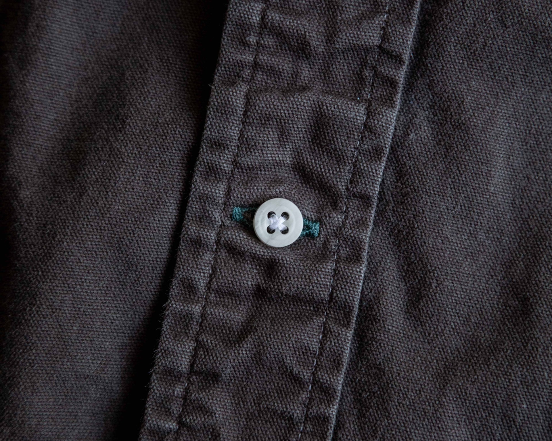 closeup of a button on a brown shirt