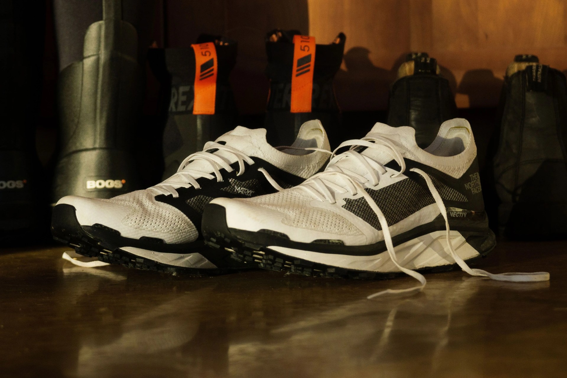 a pair of white and black trail running shoes