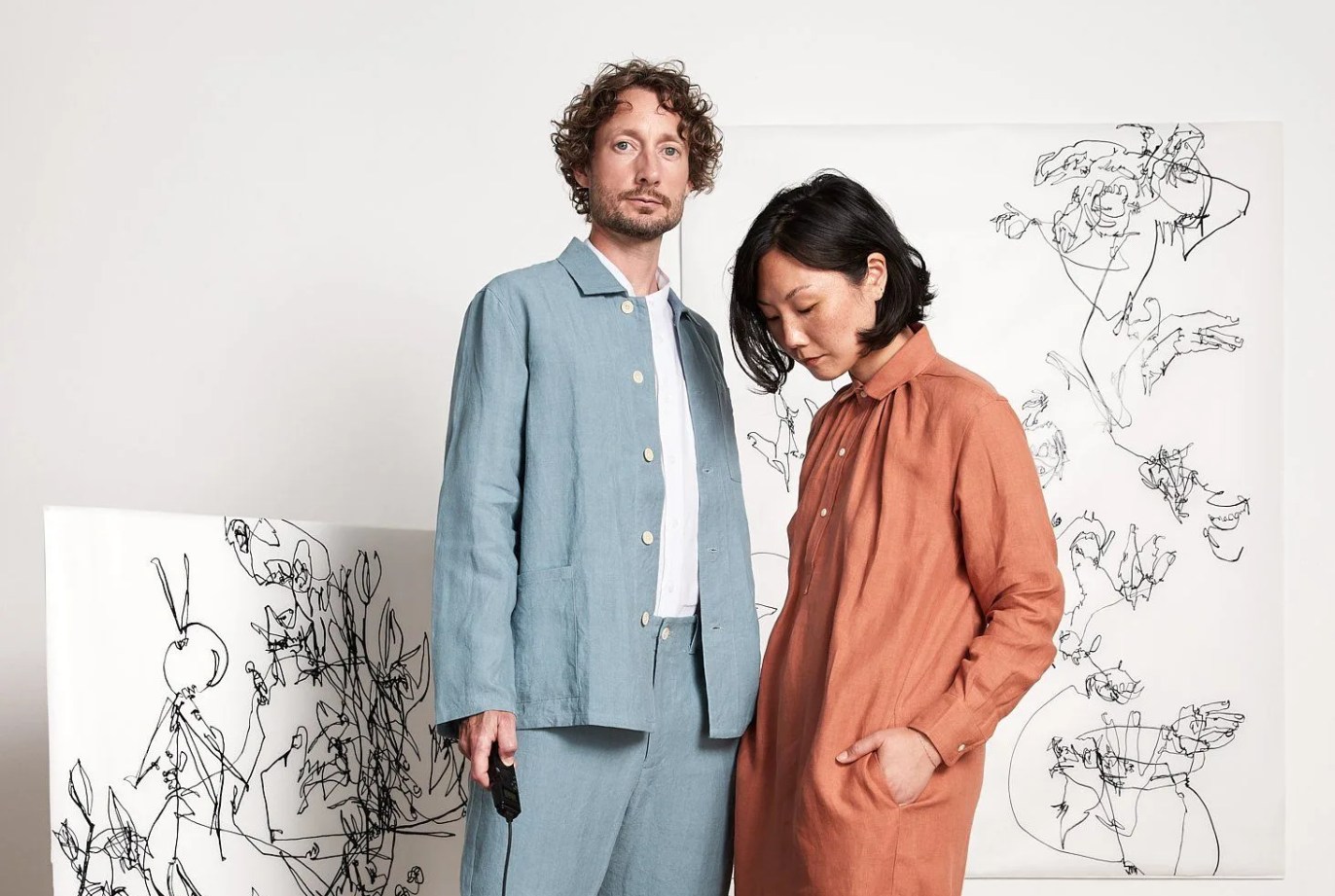 man in blue jacket, woman in orange dress