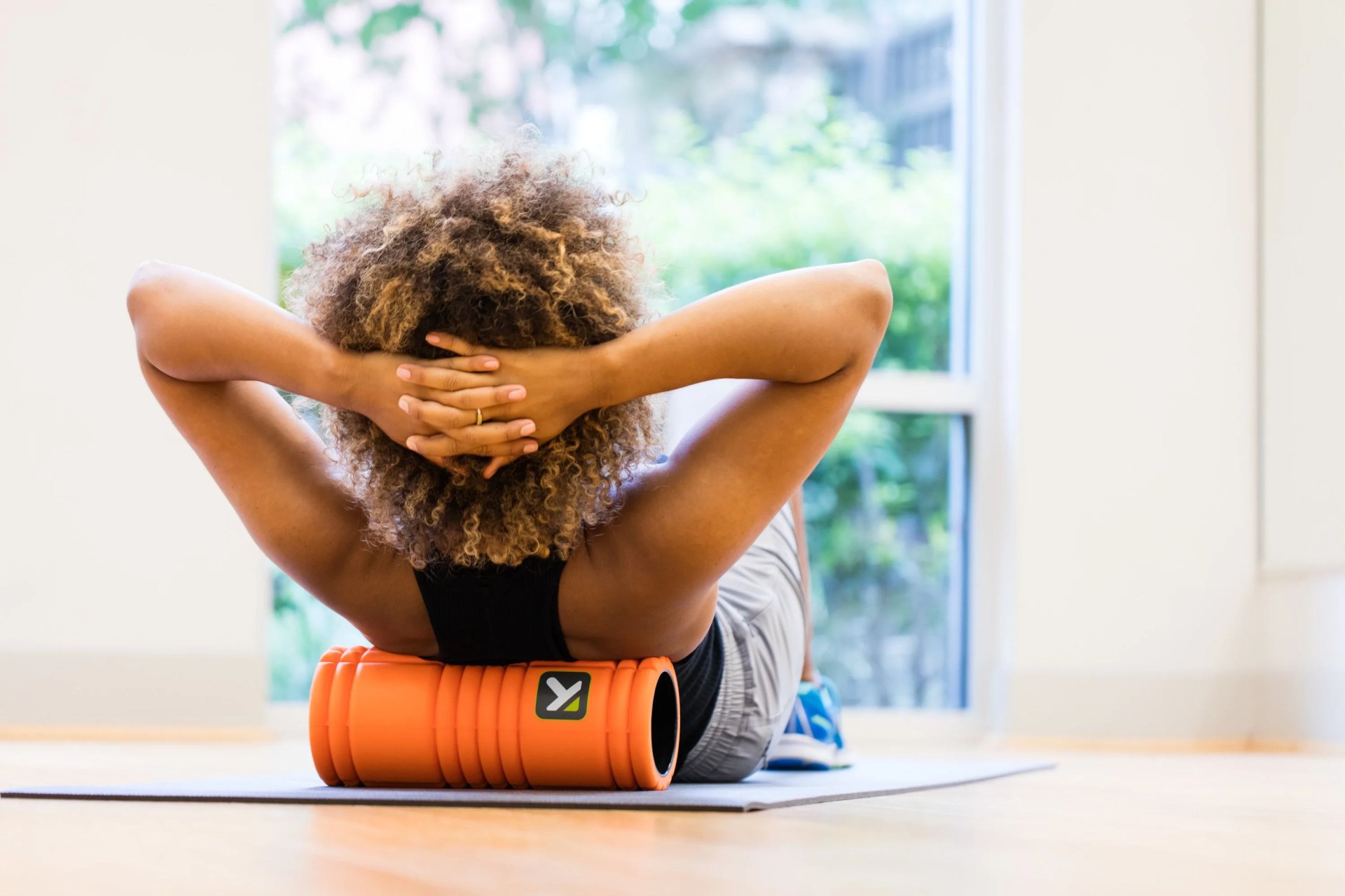 a woman using a foam roller