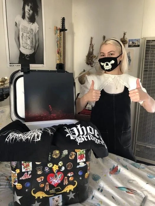 phoebe bridgers standing with a yeti cooler
