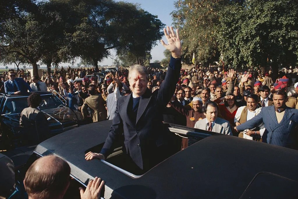 president carter waving from limousine