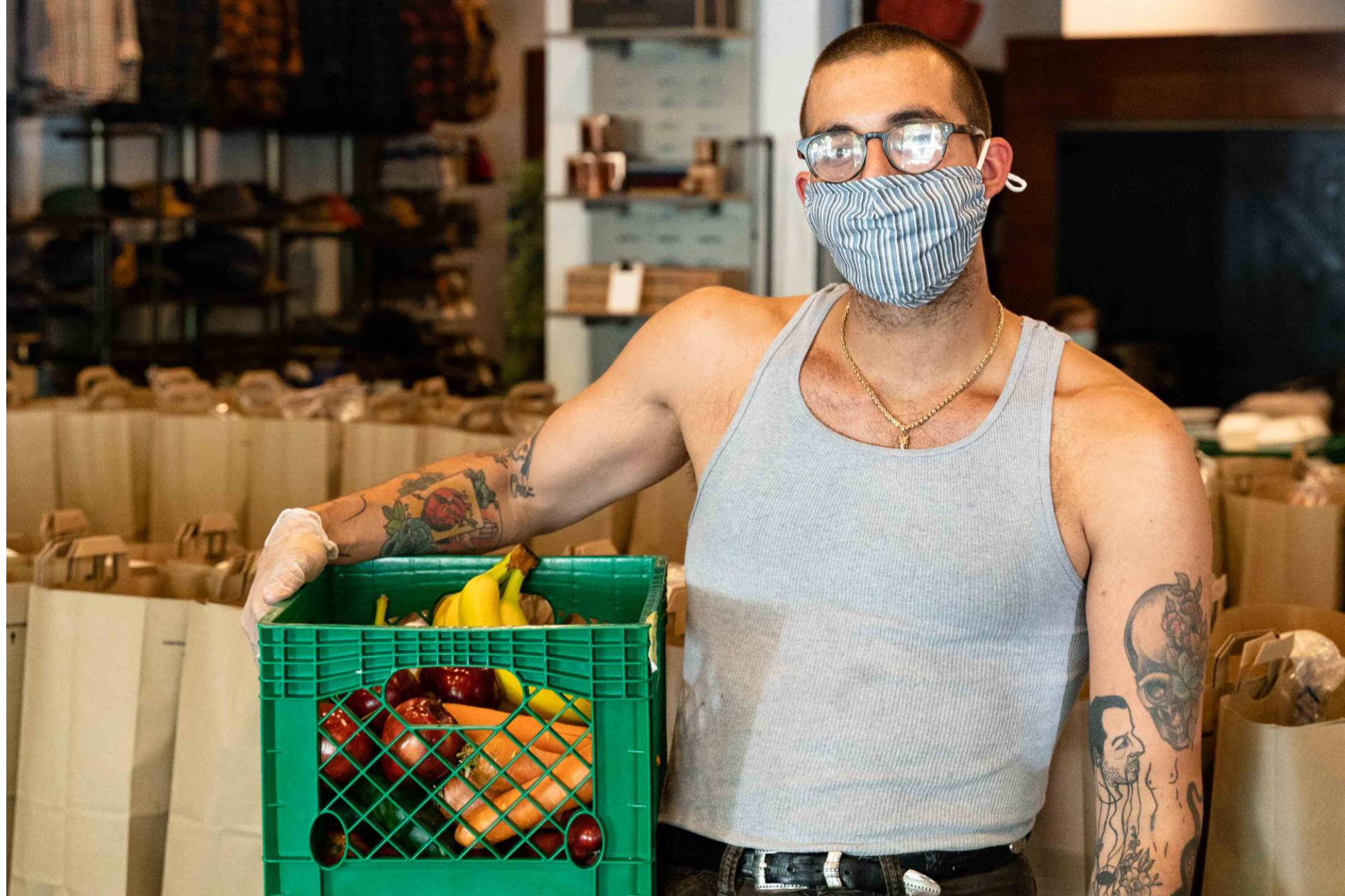 a man holding a crate of food