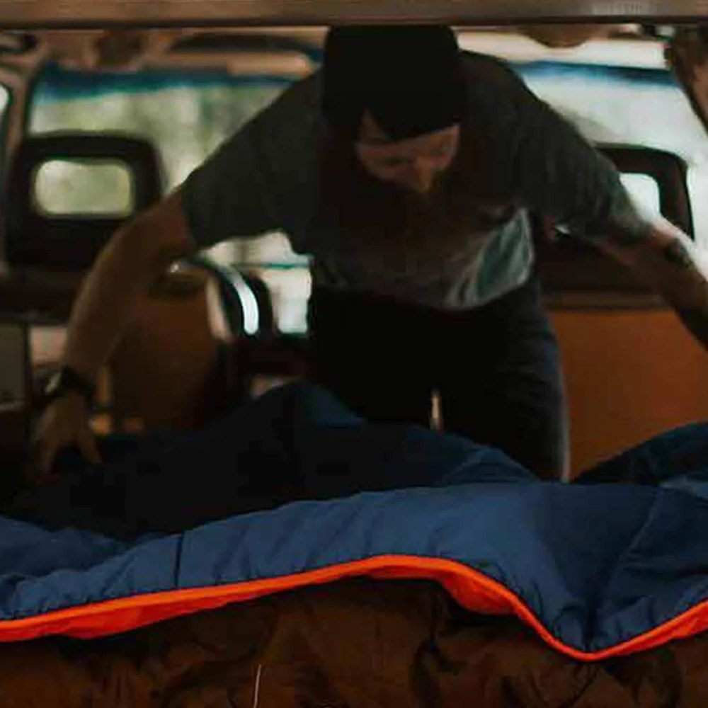 man setting up ignik heated blanket in car