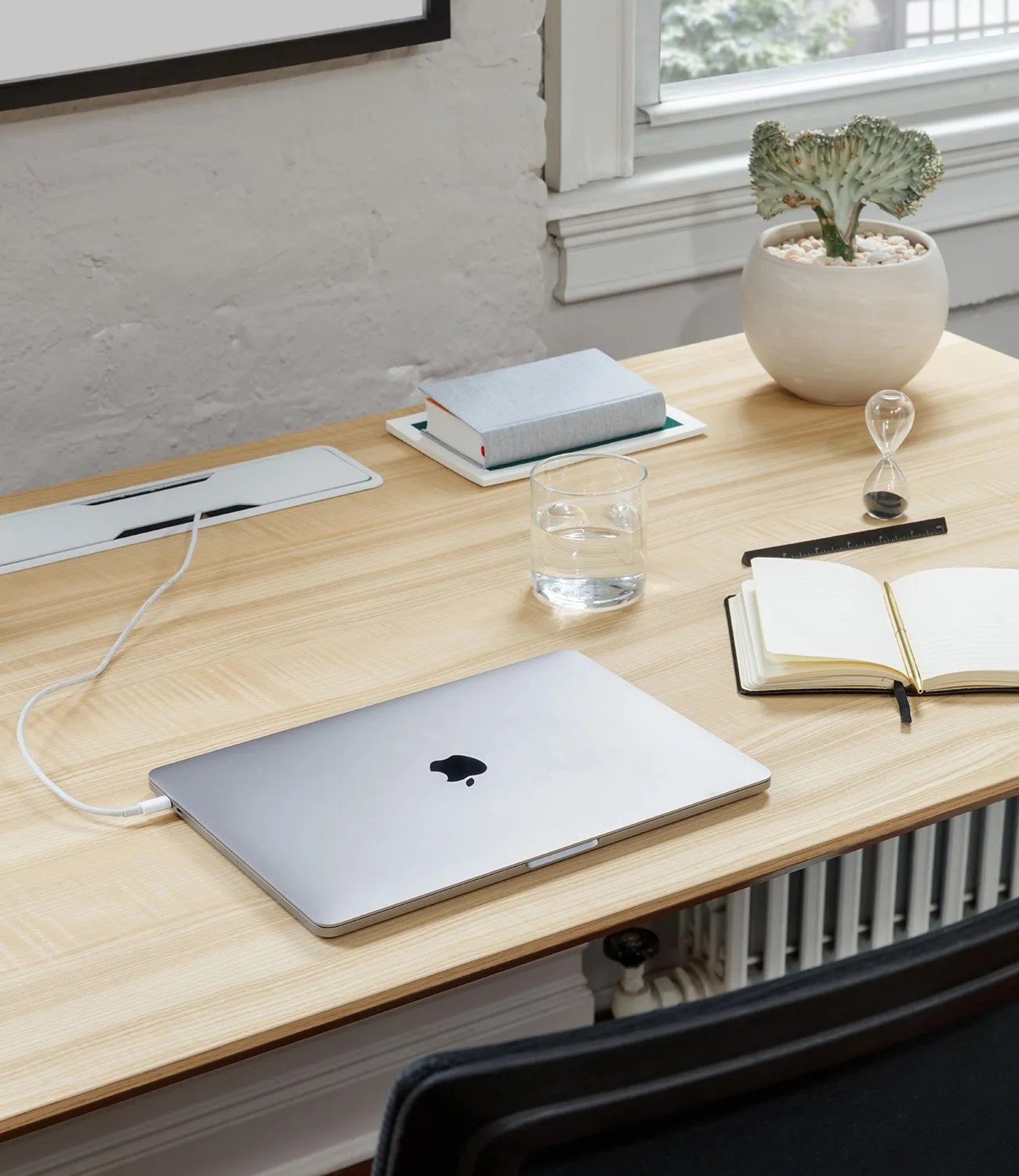 silver mac laptop sitting on top of branch desk