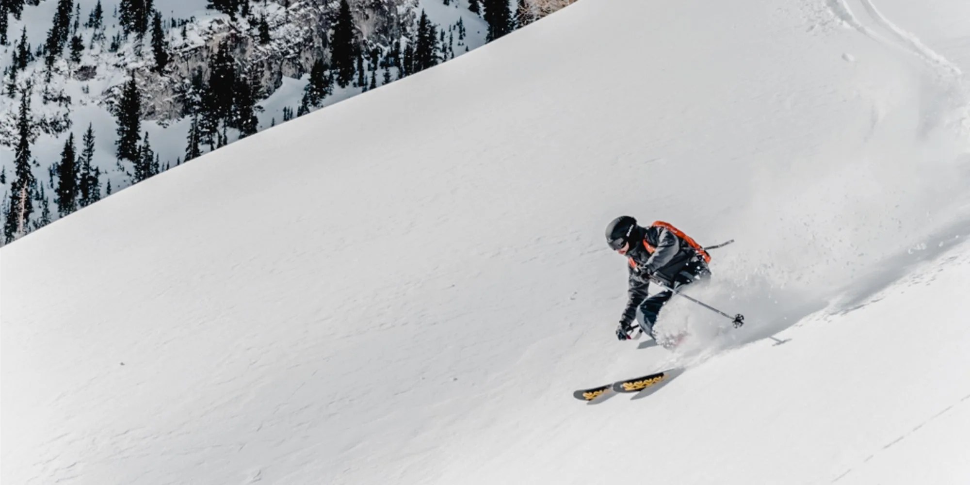 backcountry man skiing on snowy hill