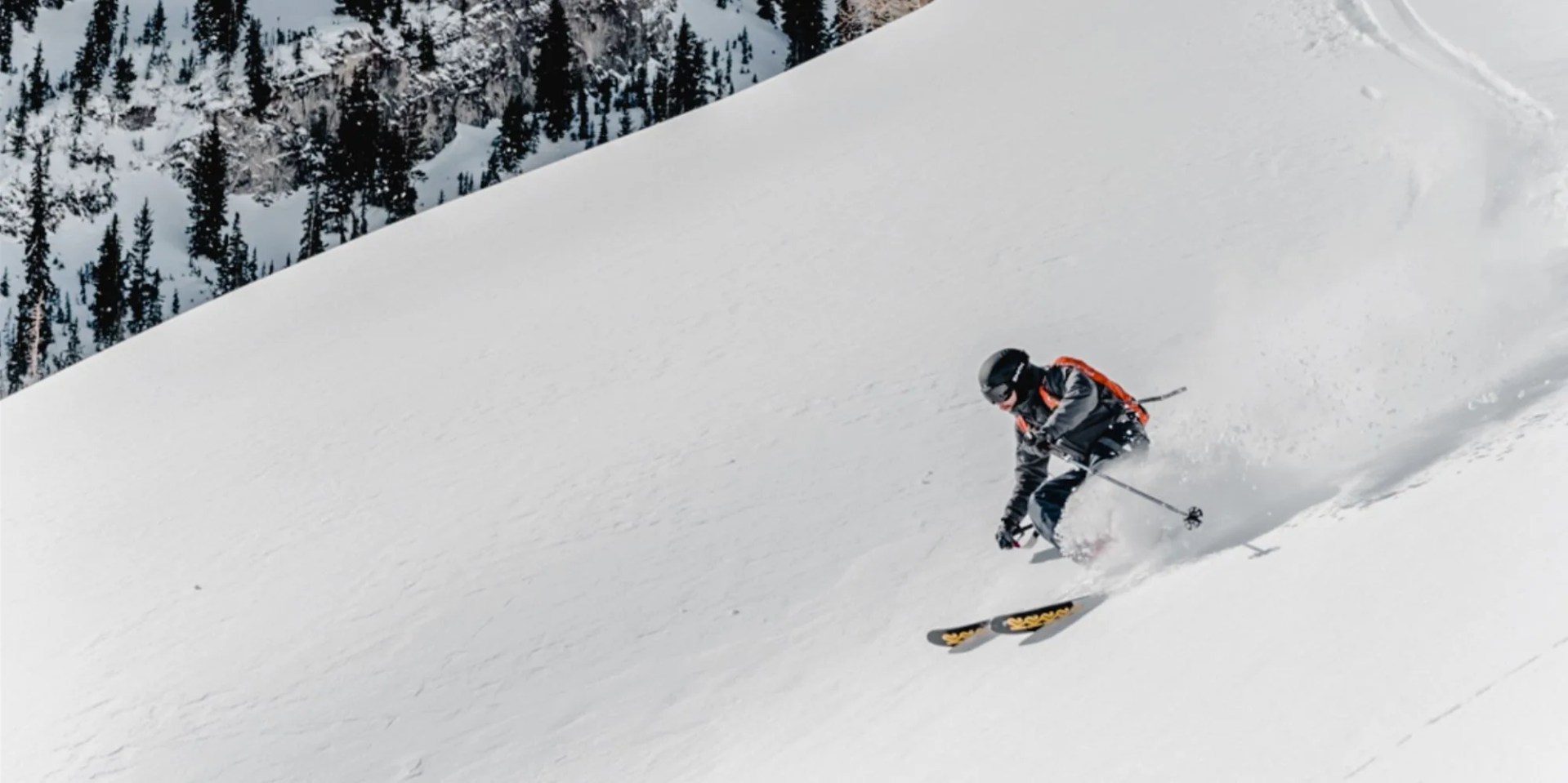 backcountry man skiing on snowy hill