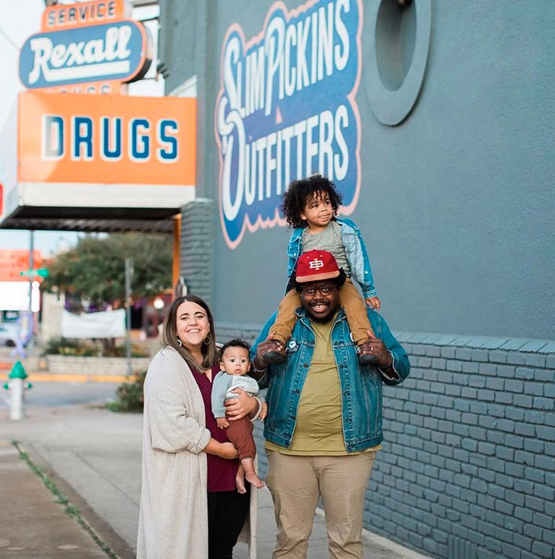 a family standing in front of a gear store