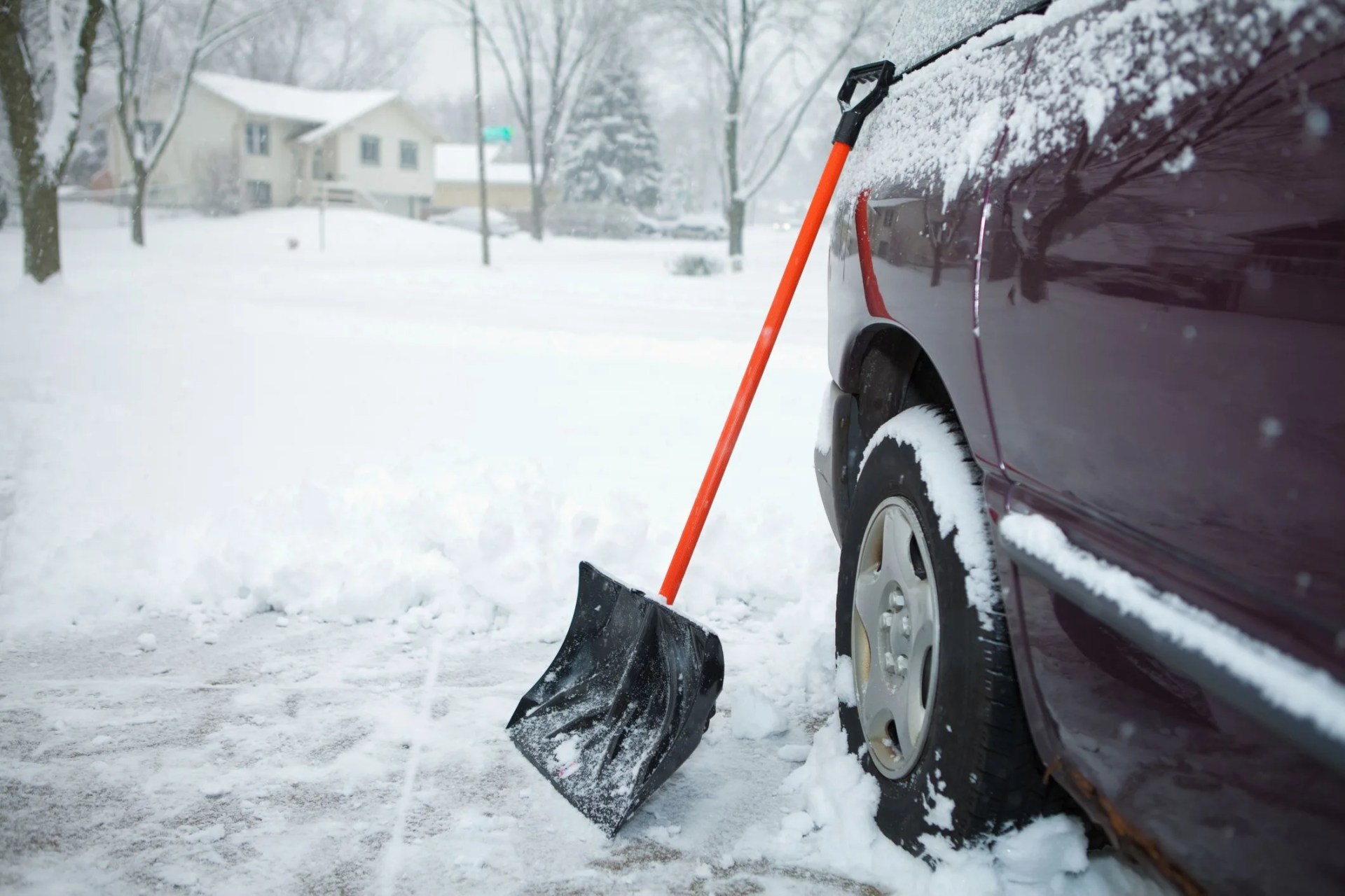 winter storm and snow shovel on driveway