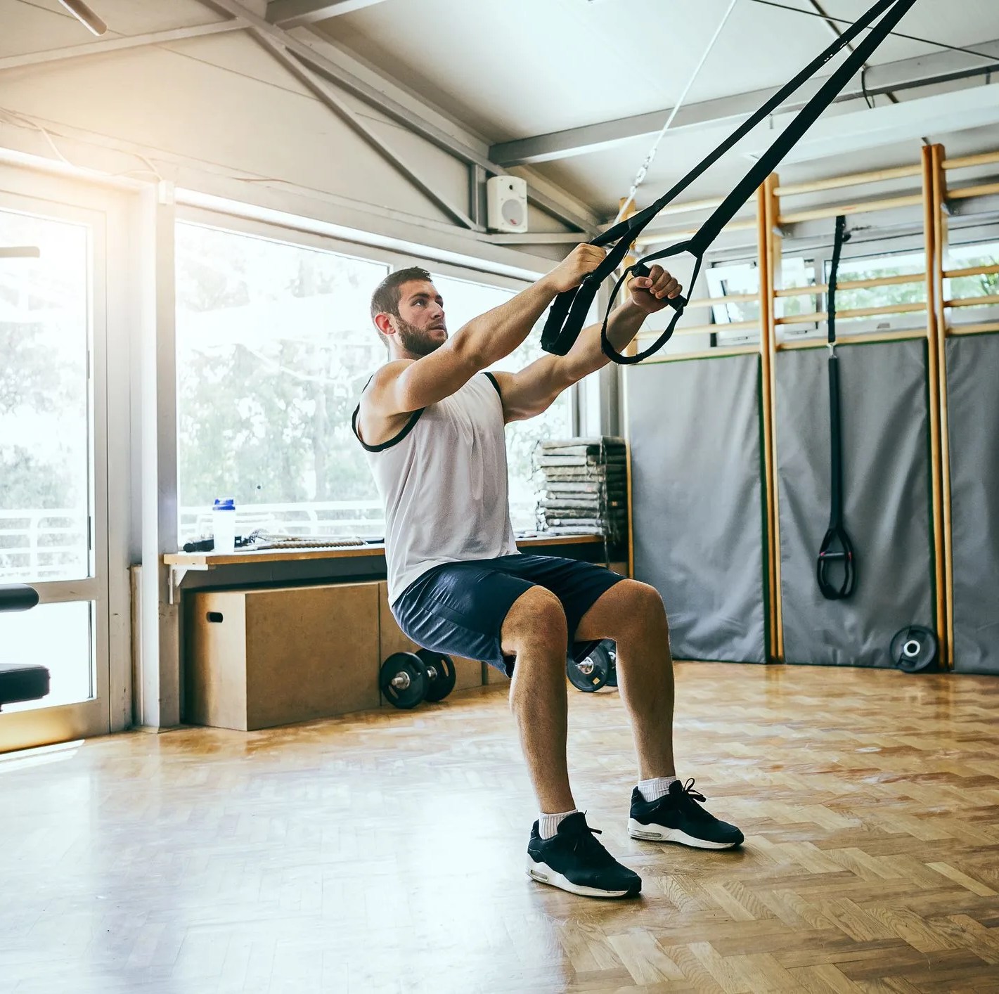young man workout with trx suspension