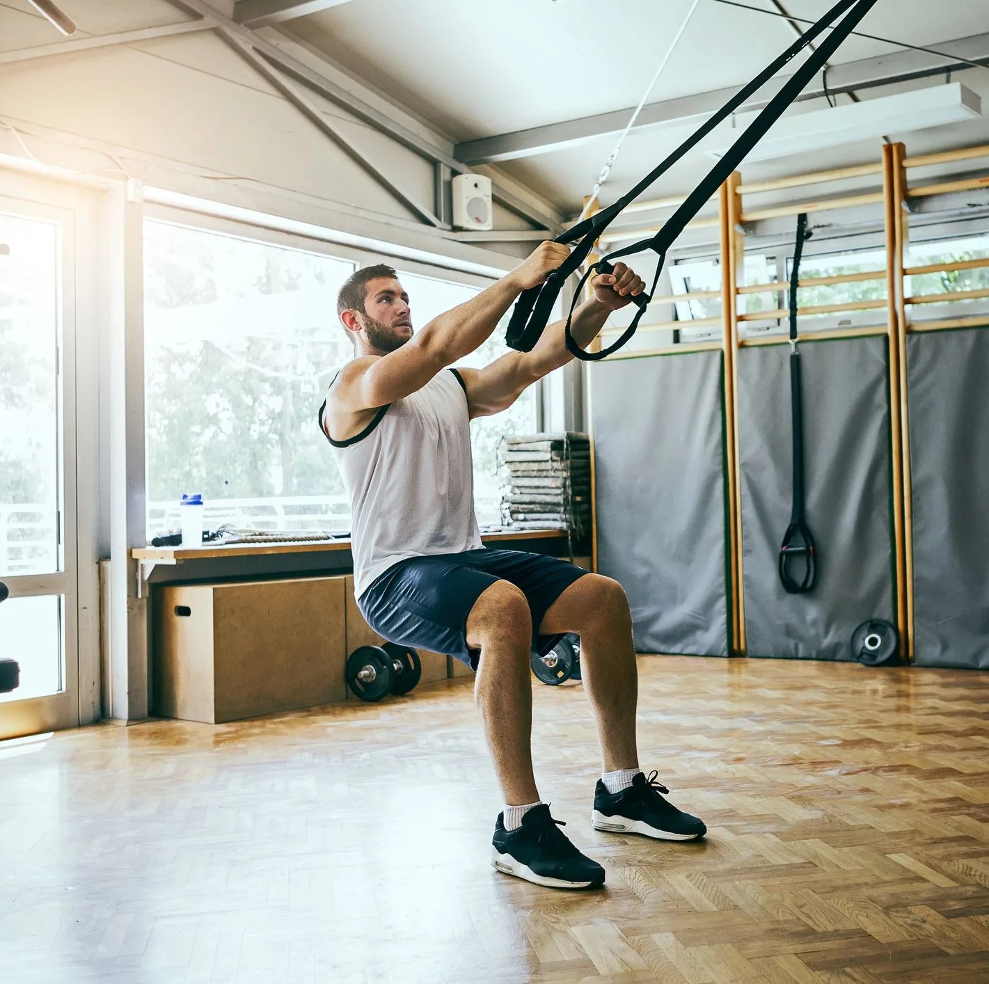 young man workout with trx suspension