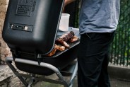 man cooking on a charcoal grll