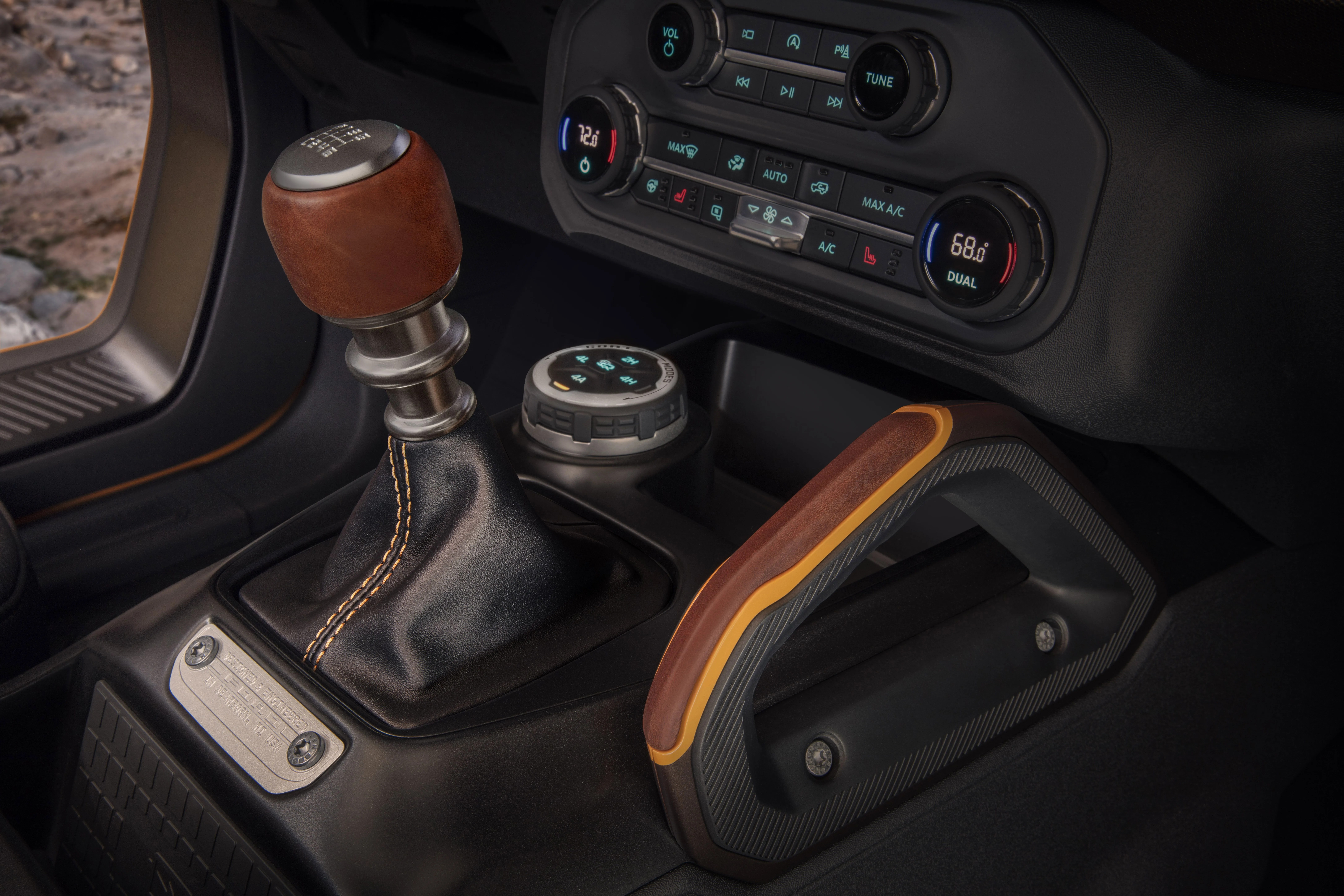 customization details include an available leather wrapped shift lever for the class exclusive 7 speed manual transmission, as well as grab handles in this prototype version of the 2021 bronco not representative of production model static display on private property with aftermarket accessories not available for sale
