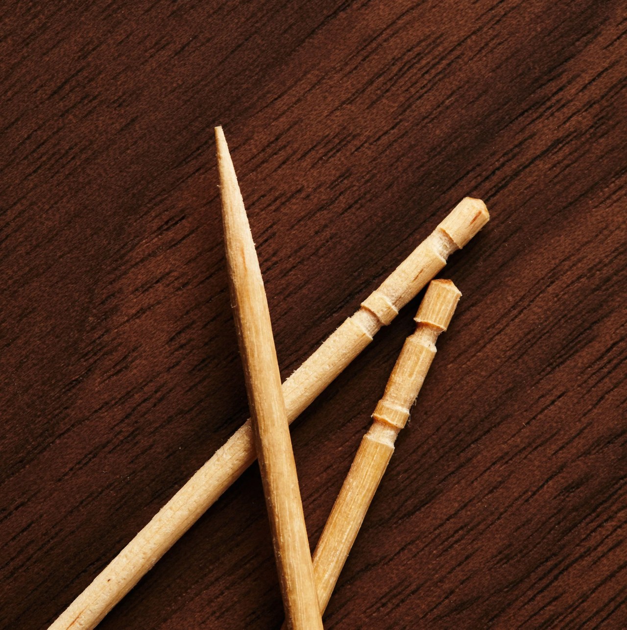 three toothpicks on wooden table