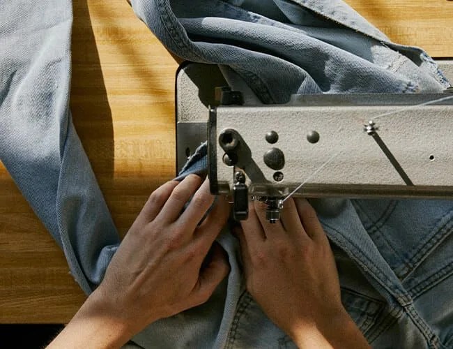 hands sewing jeans