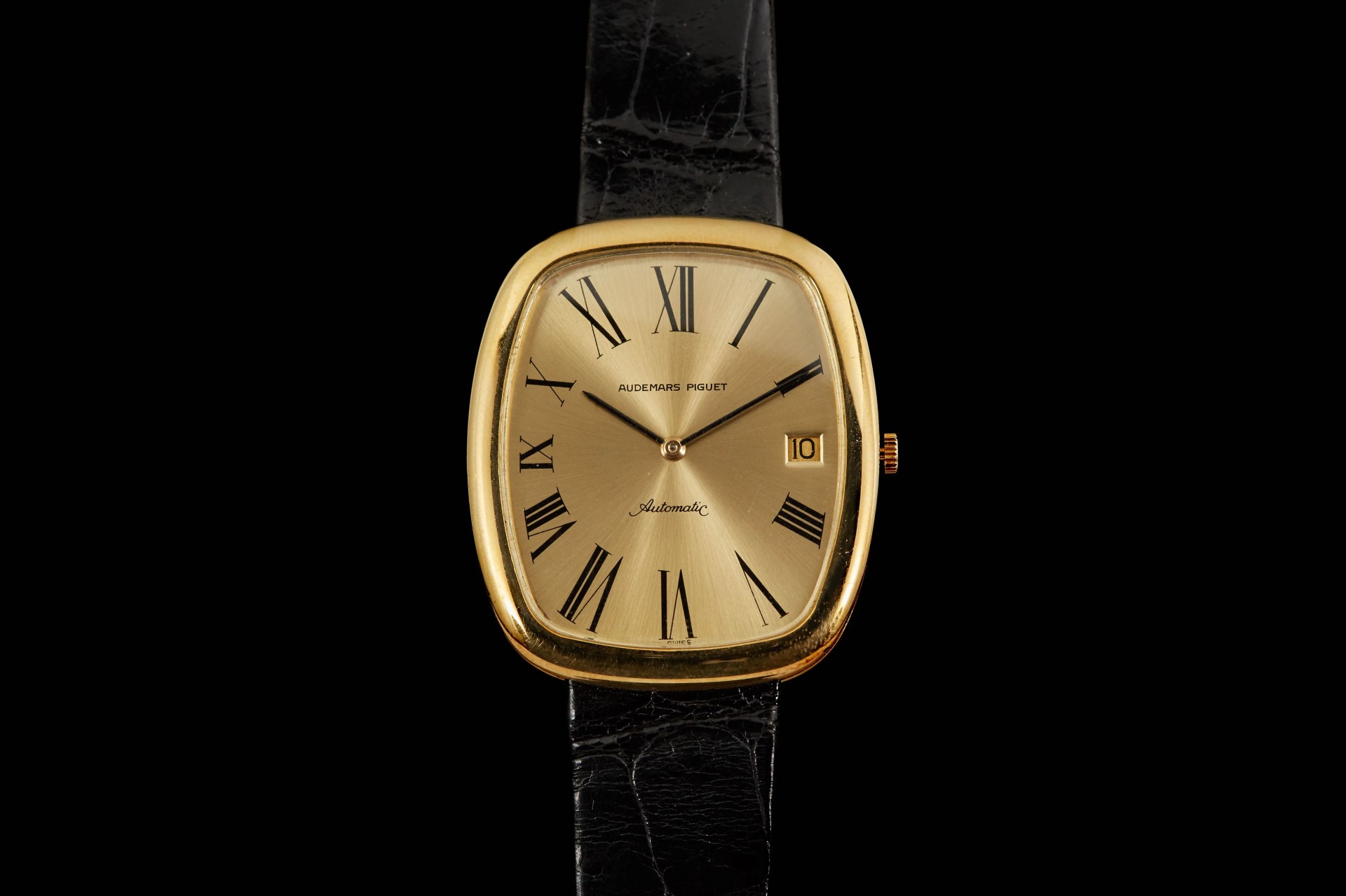 gold dress watch on black strap