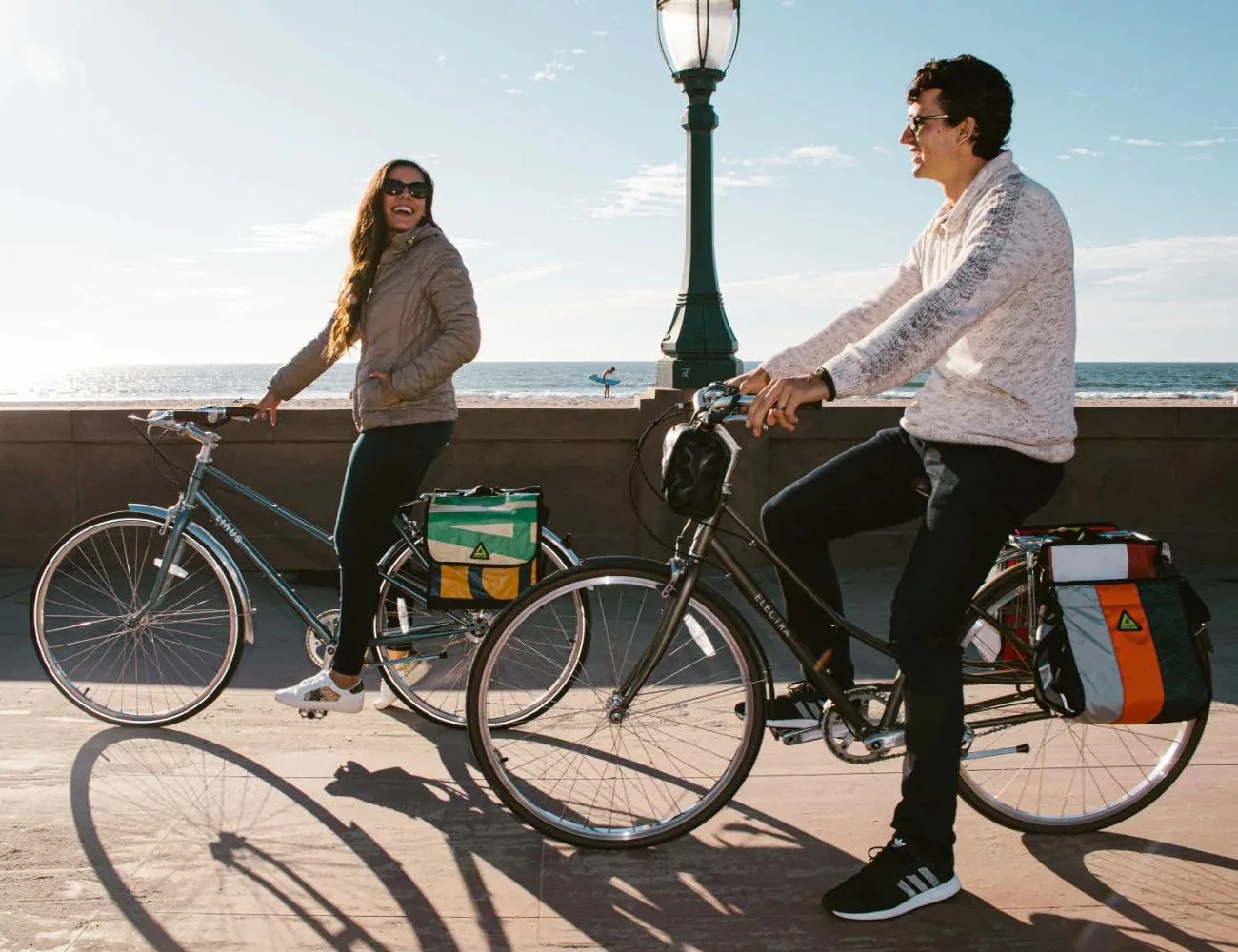 couple on bikes with green guru packs