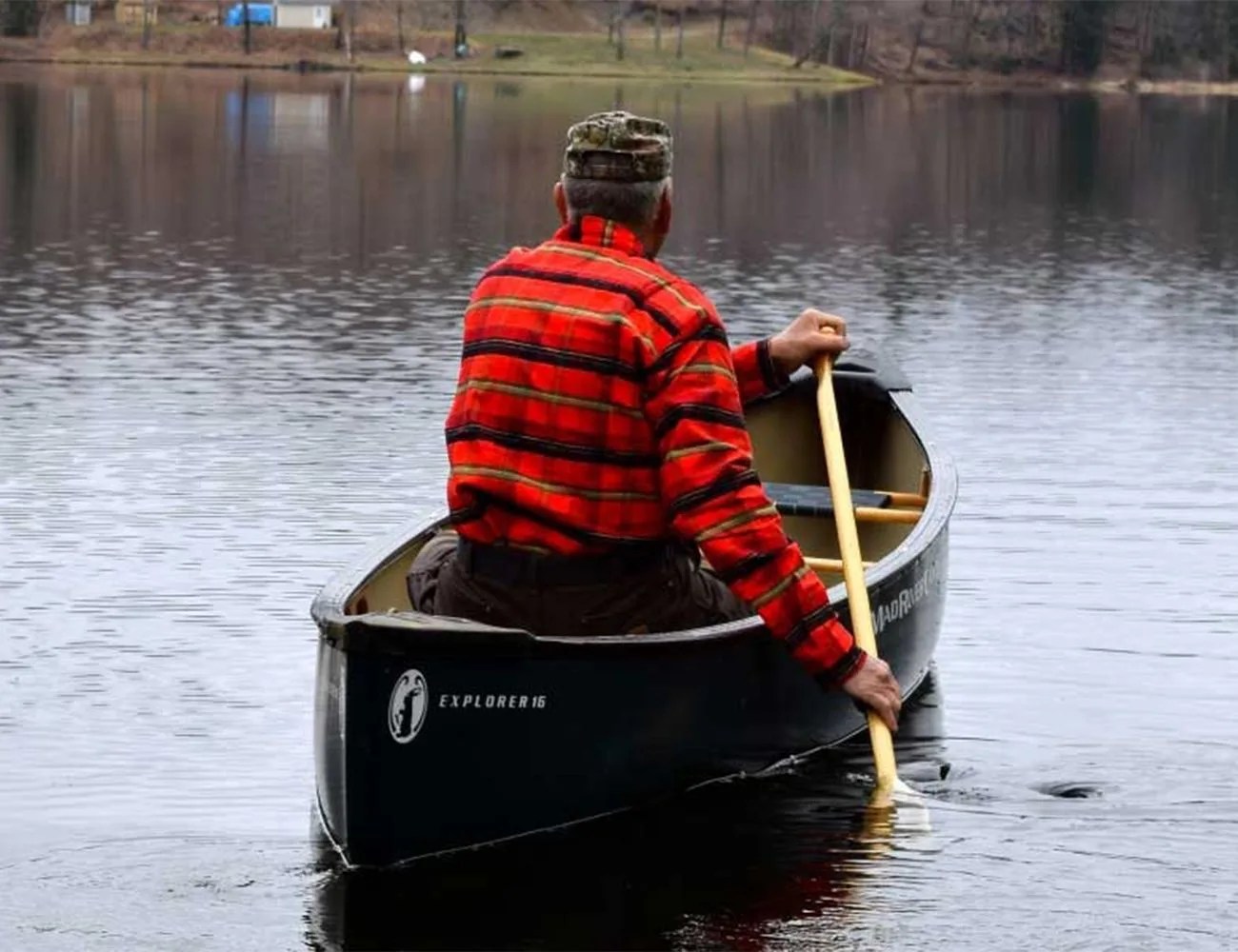 man in a canoe wearing a johnson woolen mills flannel
