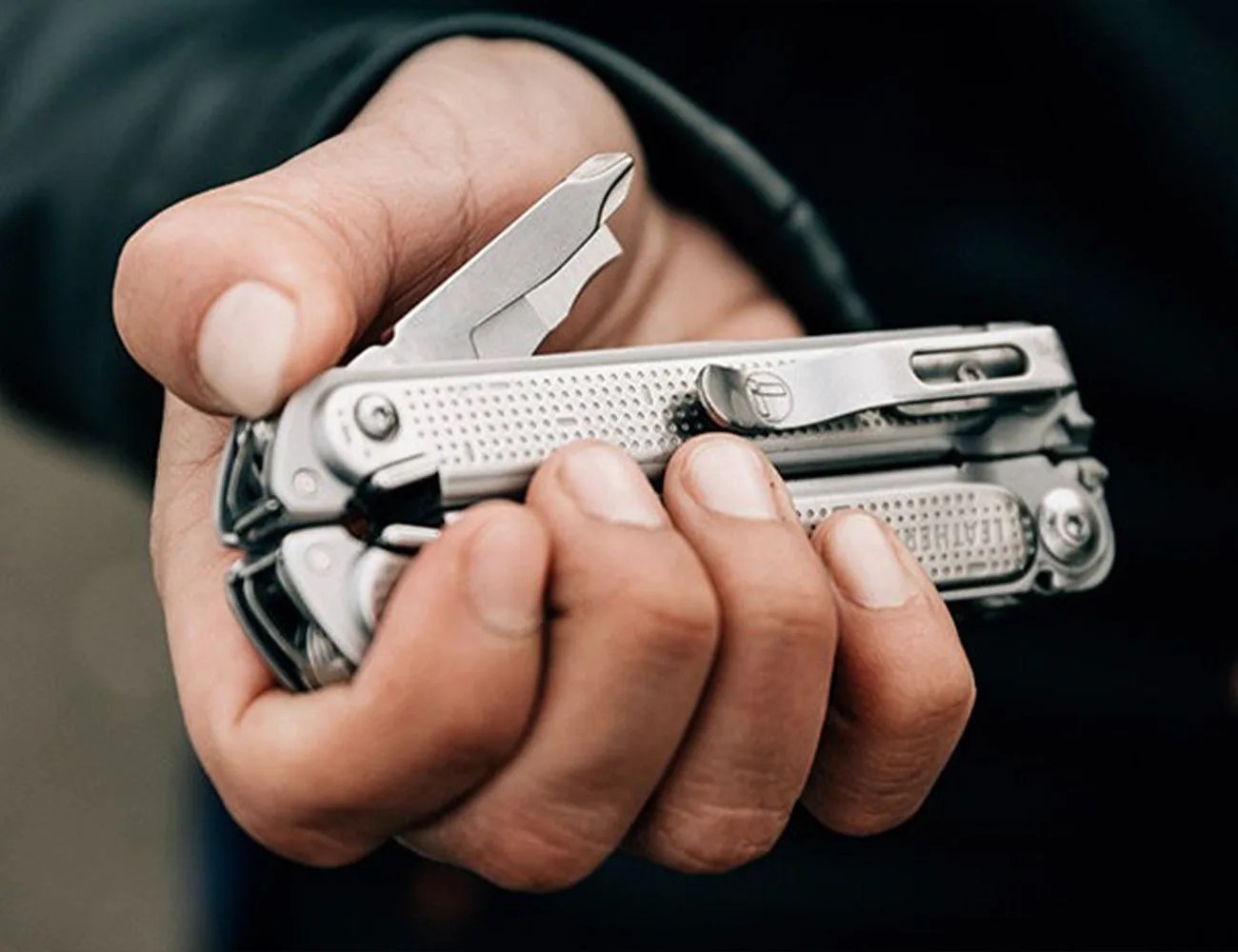 a leatherman tool in someones hand
