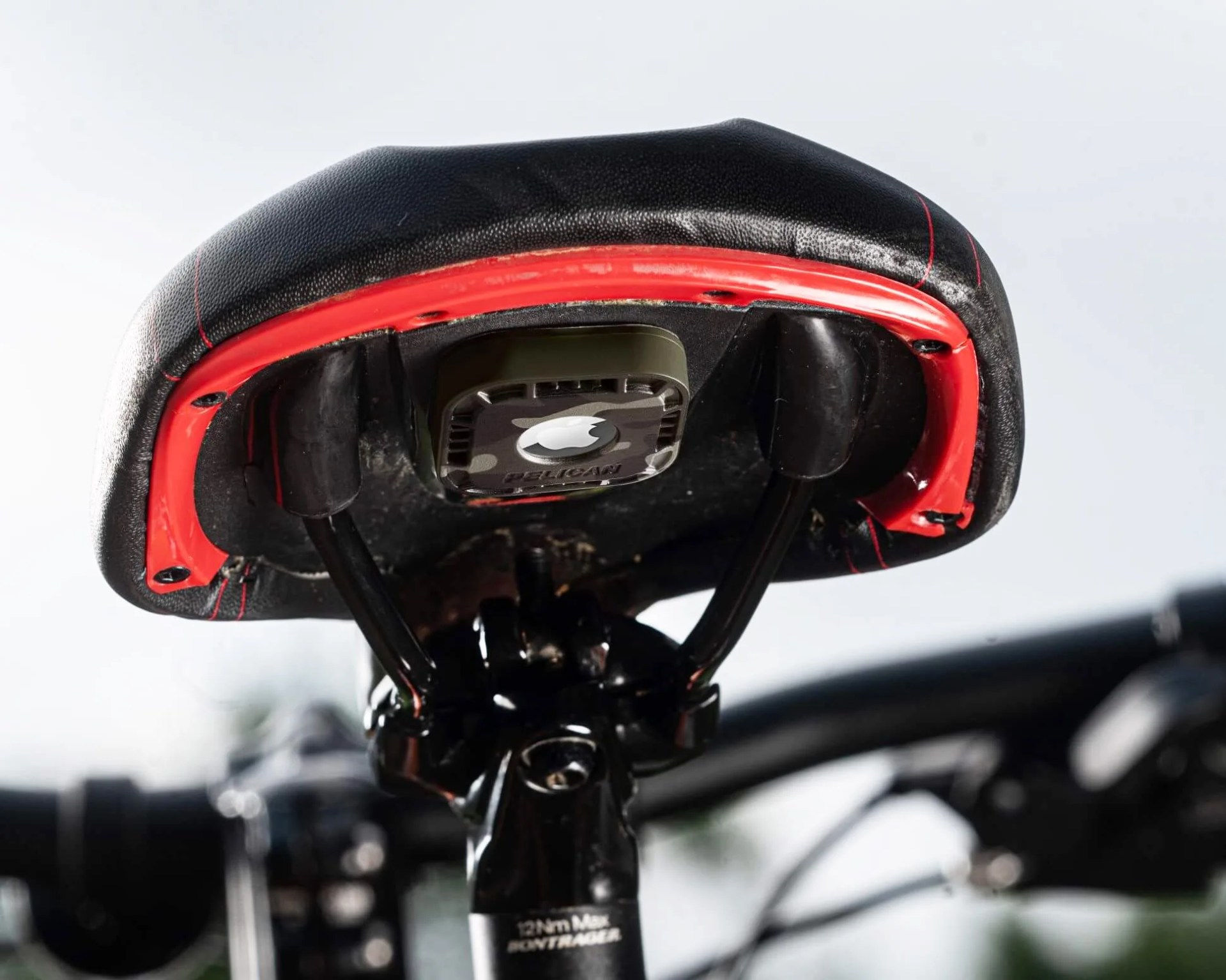 airtag in a pelican case attached to bottom of a bike seat