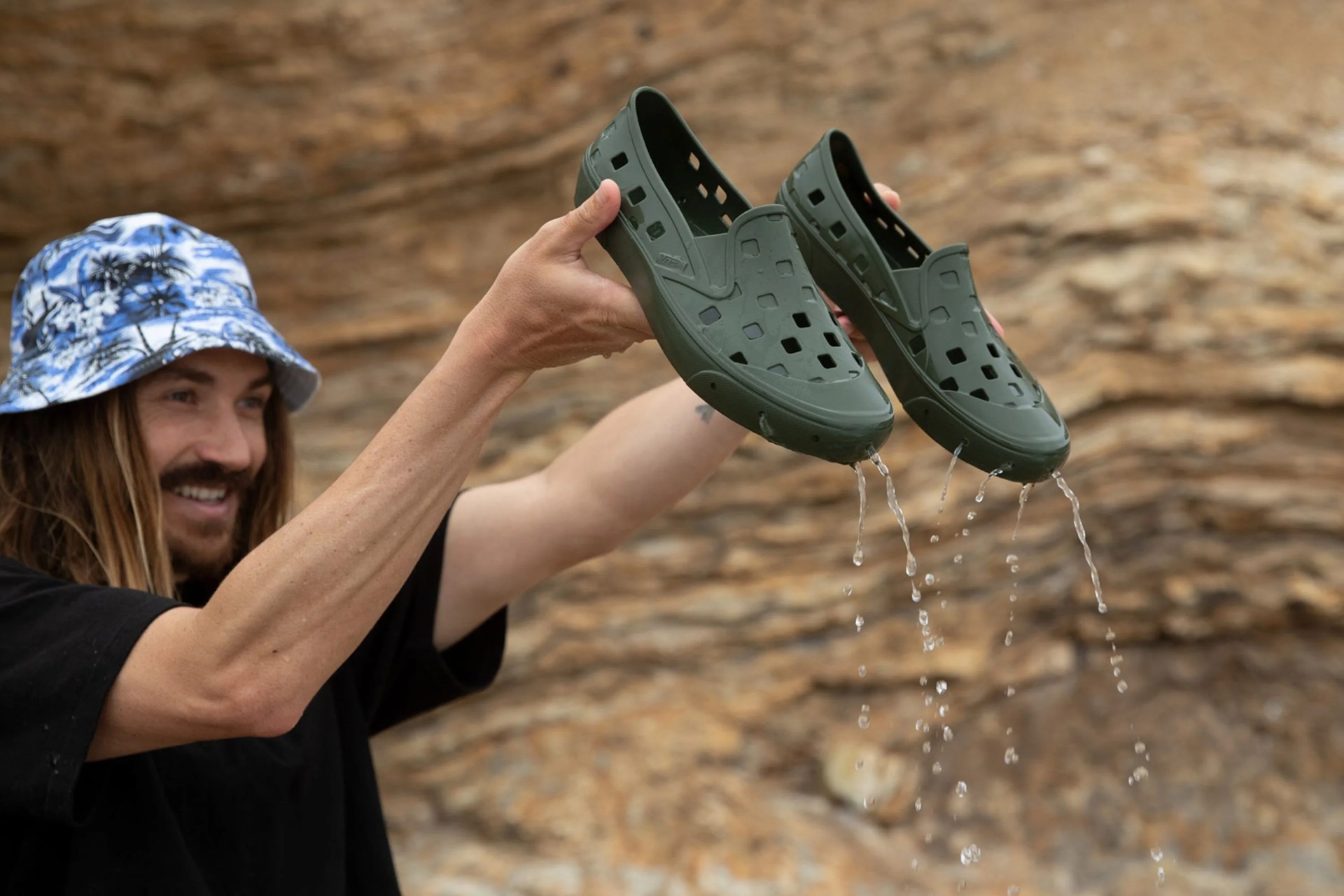 man holding vans trek slip on in grape leaf