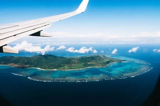 flying over a tropical island with coral reefs, ishigaki island of the yaeyama islands, okinawa, japan