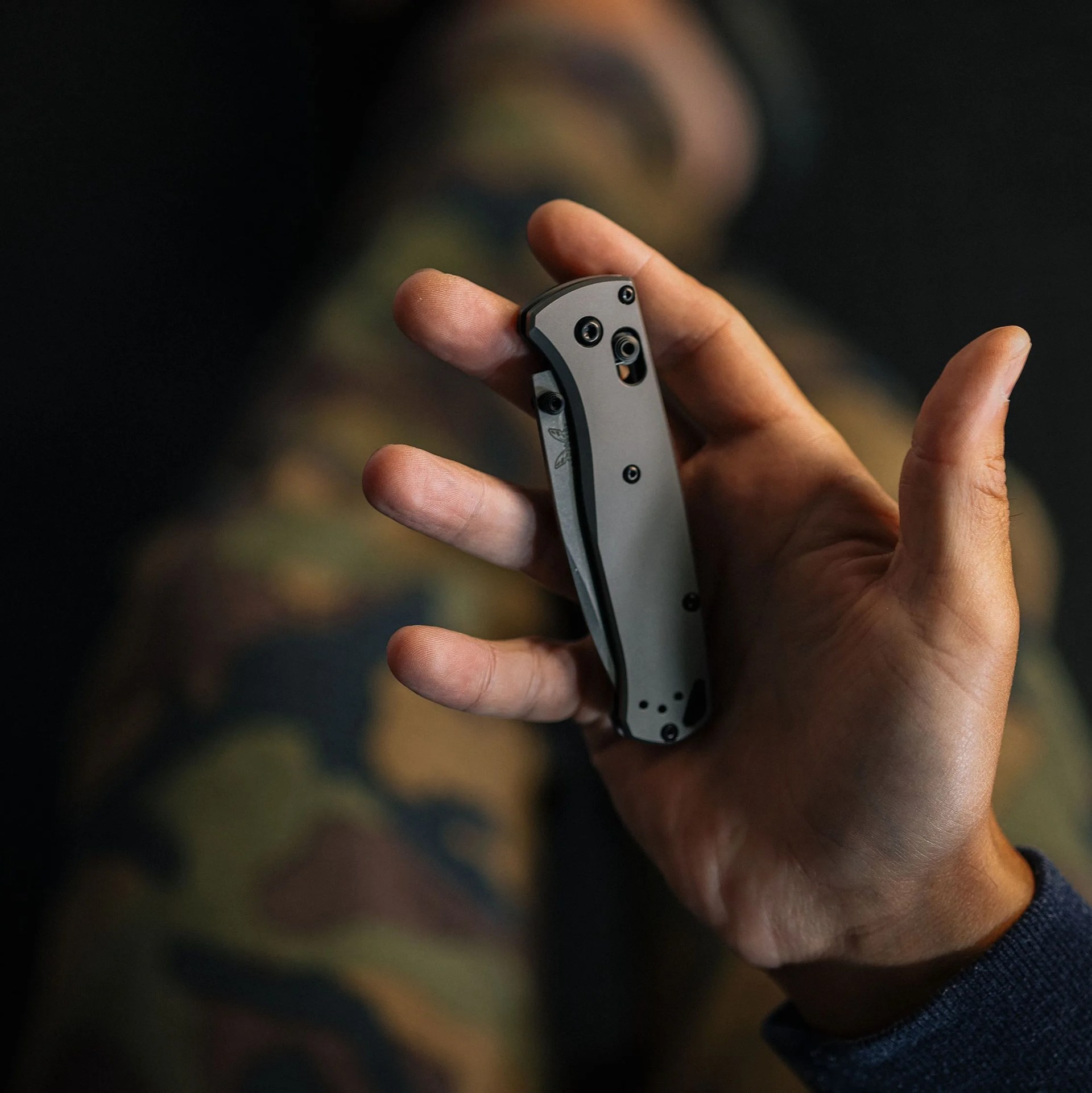 a hand holding a folding pocket knife