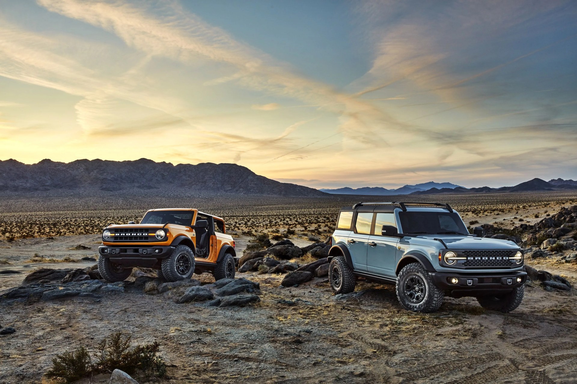 pre production versions of the 2021 bronco, shown here, include bronco two door in cyber orange metallic tri coat and bronco four door in cactus gray