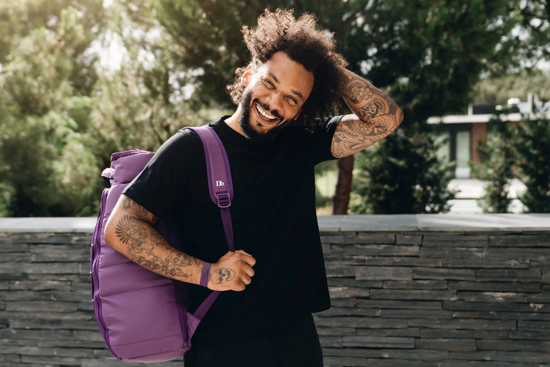 db bags man wearing purple backpack