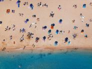 aerial top view of people sitting on a sandy beach