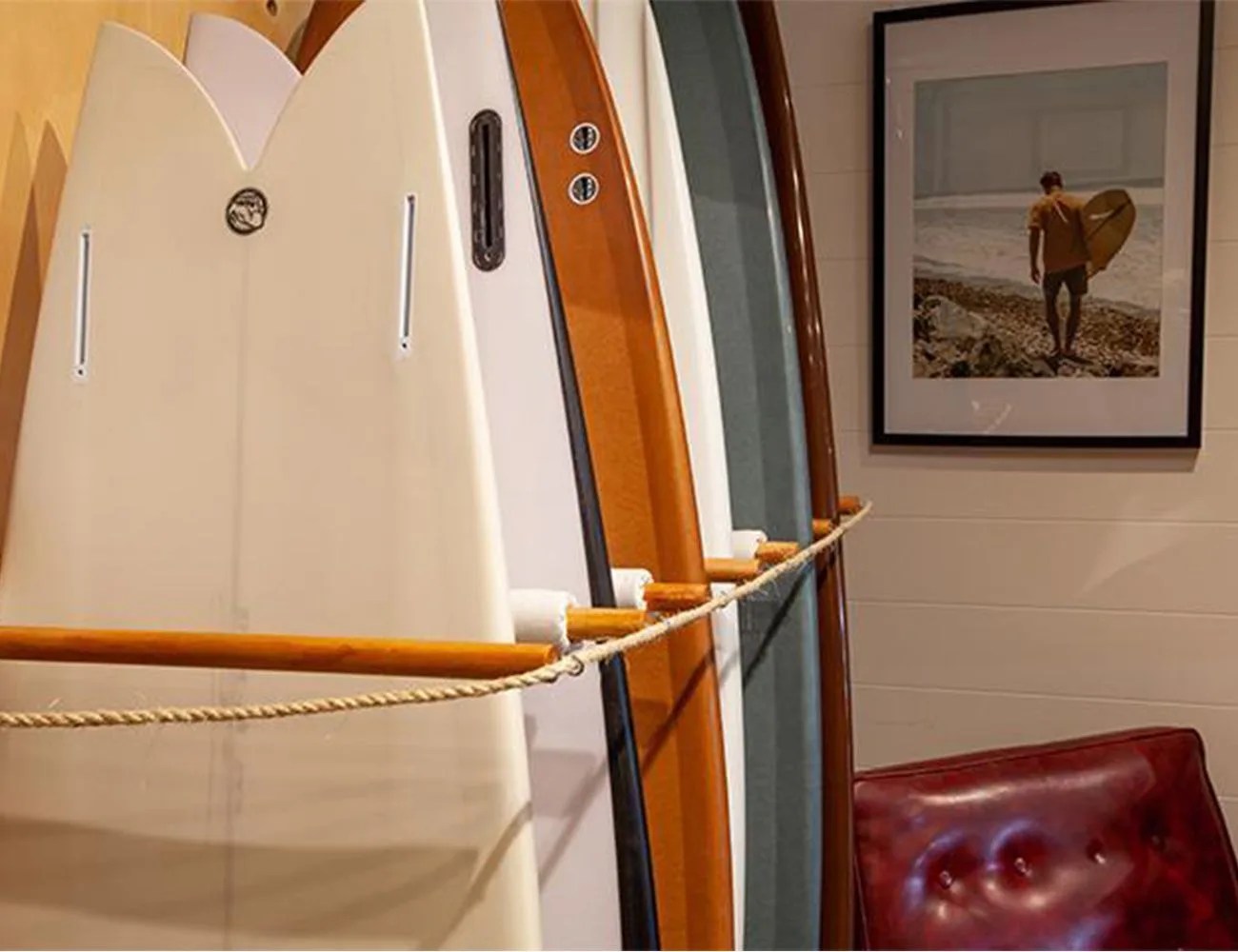 rhythm store interior surf boards lined up against the wall and framed picture of a surfer