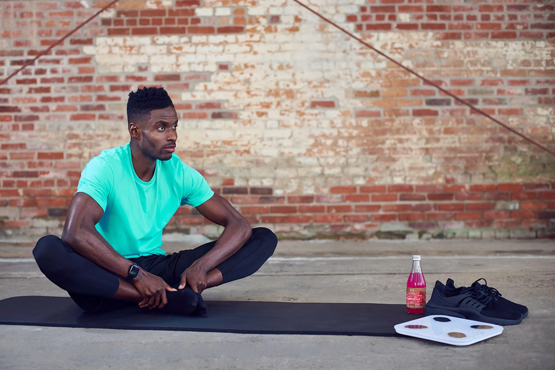 man sitting cross legged next to his fittrack scale