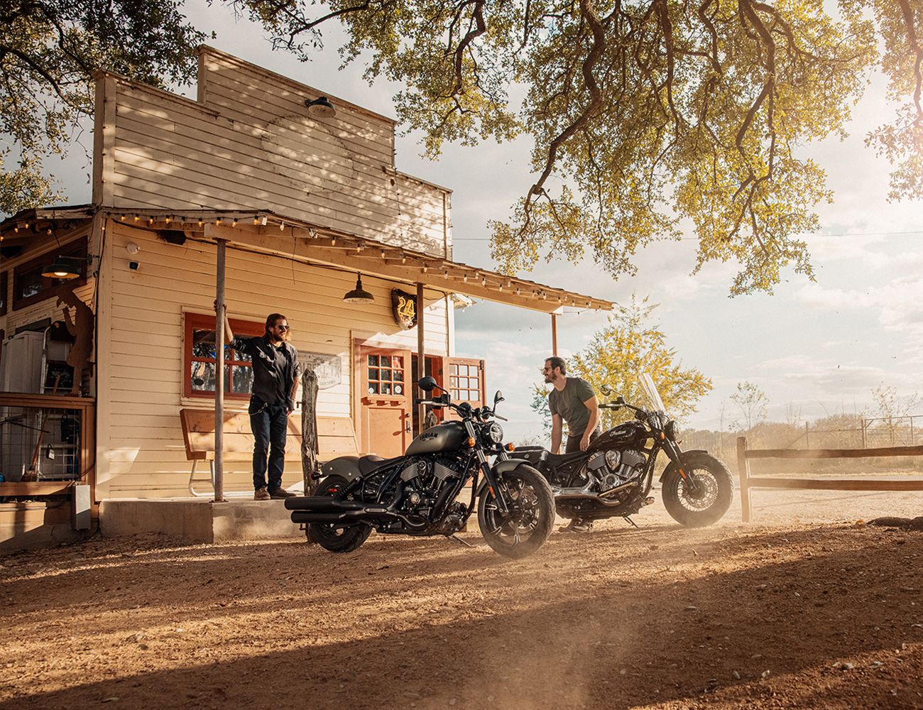 two people standing by their 2022 chief dark horse motorcycles