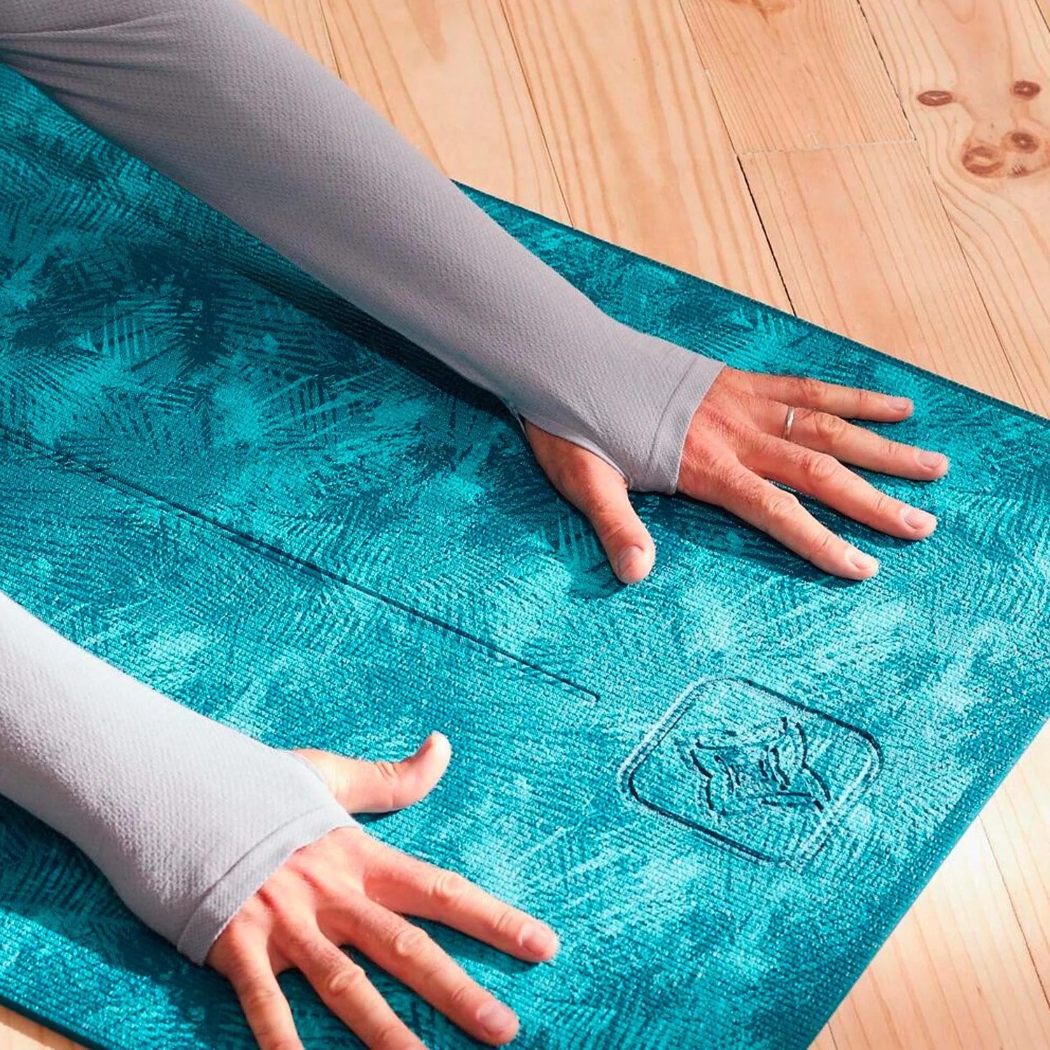 a person stretching on a blue yoga mat
