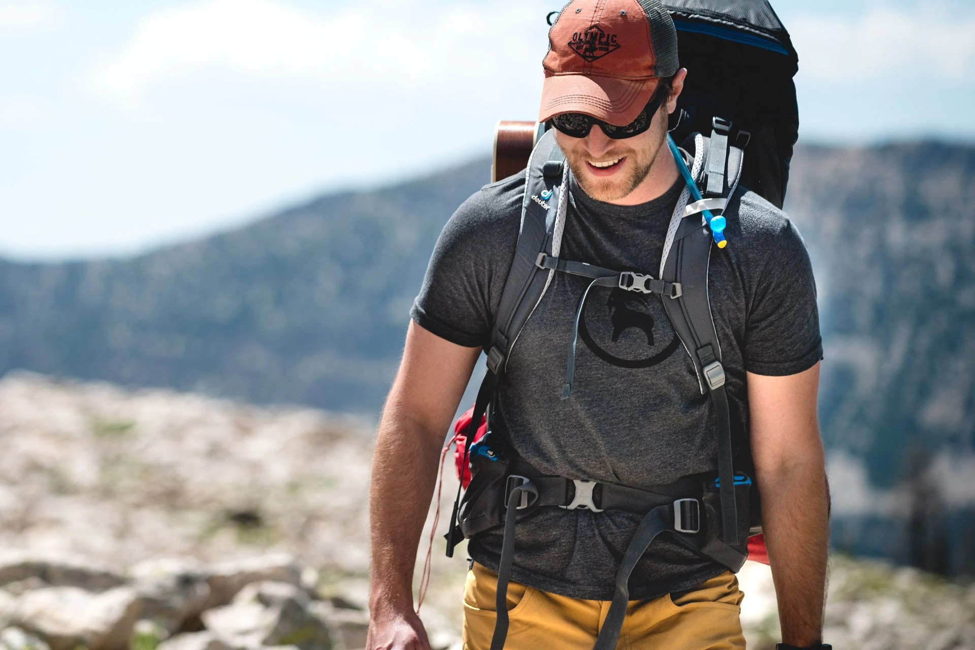 man hiking wearing backcountry gear
