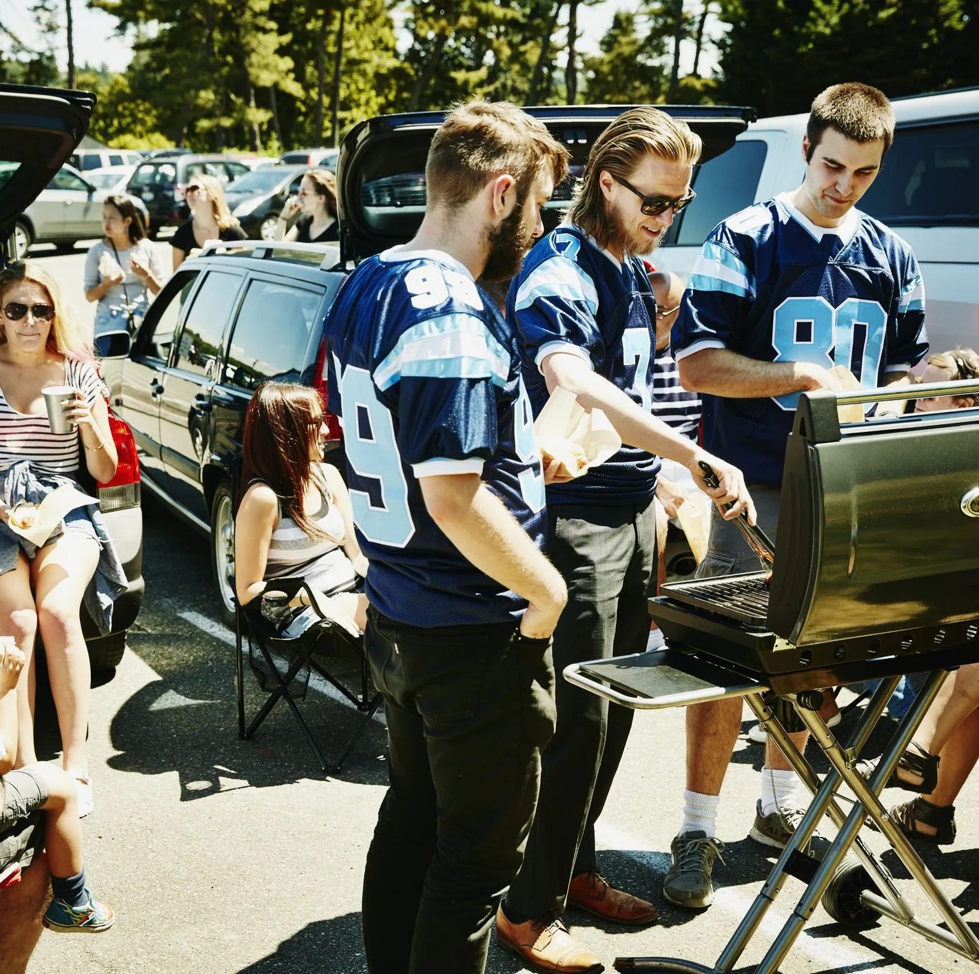 friends barbecuing during tailgating party