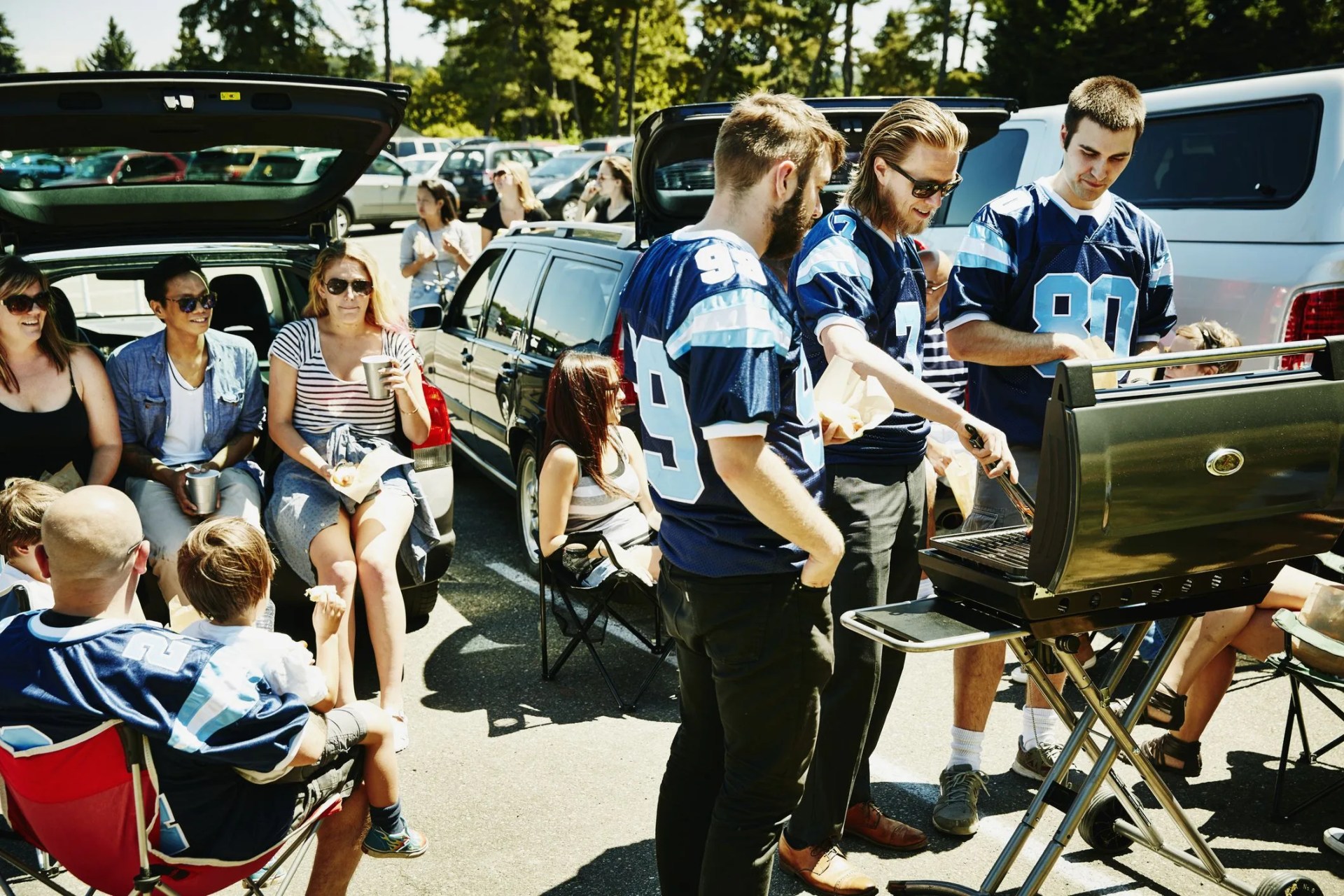friends barbecuing during tailgating party