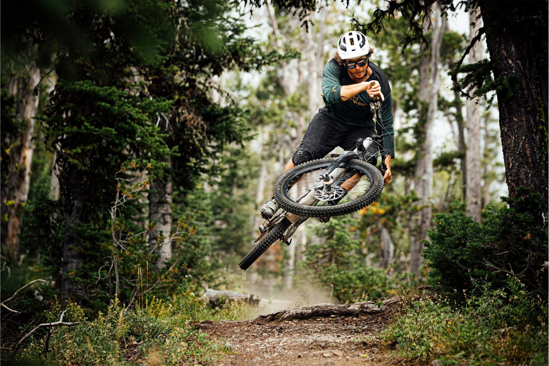man wearing sweet protection helmet doing a bike trick