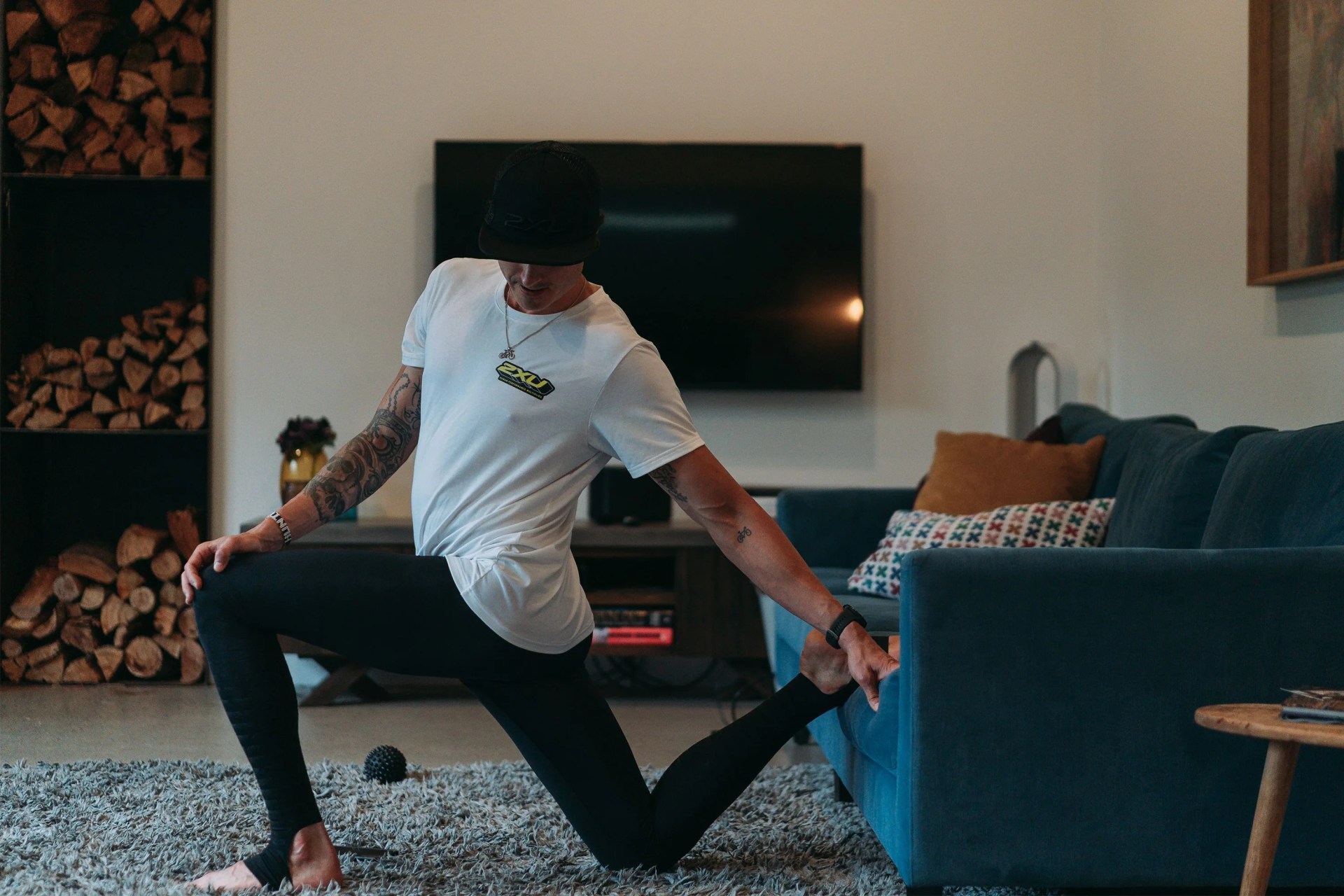 man stretching while wearing 2xu legging